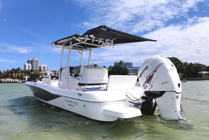 Slide: The Image of 2021 Caymas 26 HB boat in scenic waterfront setting with clear skies. - 2