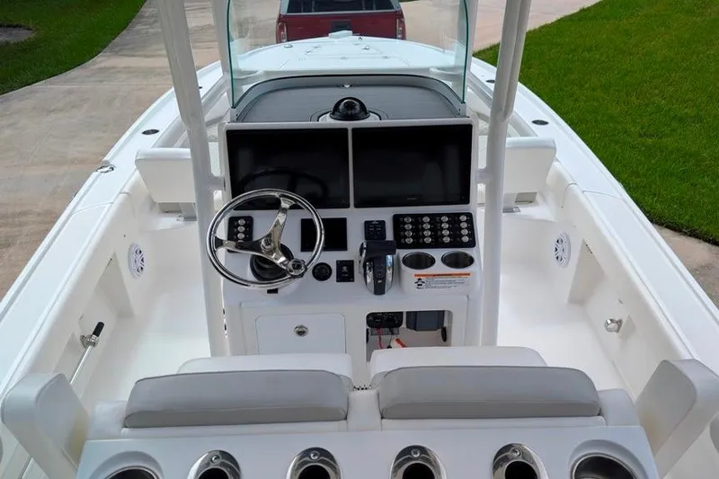Slide: The Image of 2021 Caymas 26 HB boat cockpit with steering wheel and control panel. - 4