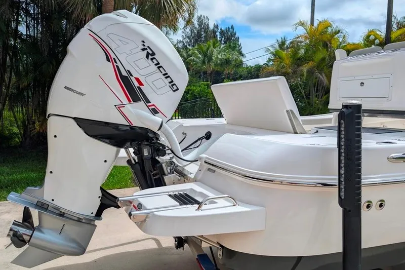 Slide: The Image of 2021 Caymas 26 HB boat with Mercury Racing 400 outboard motor, docked outdoors. - 7