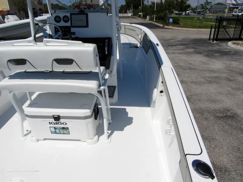 Slide: The Image of 2024 Wellcraft 202 Fisherman boat interior with Igloo cooler and steering console. - 13