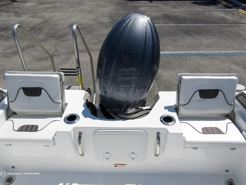 Slide: The Image of 2024 Wellcraft 202 Fisherman boat stern with dual seats and outboard motor. - 21