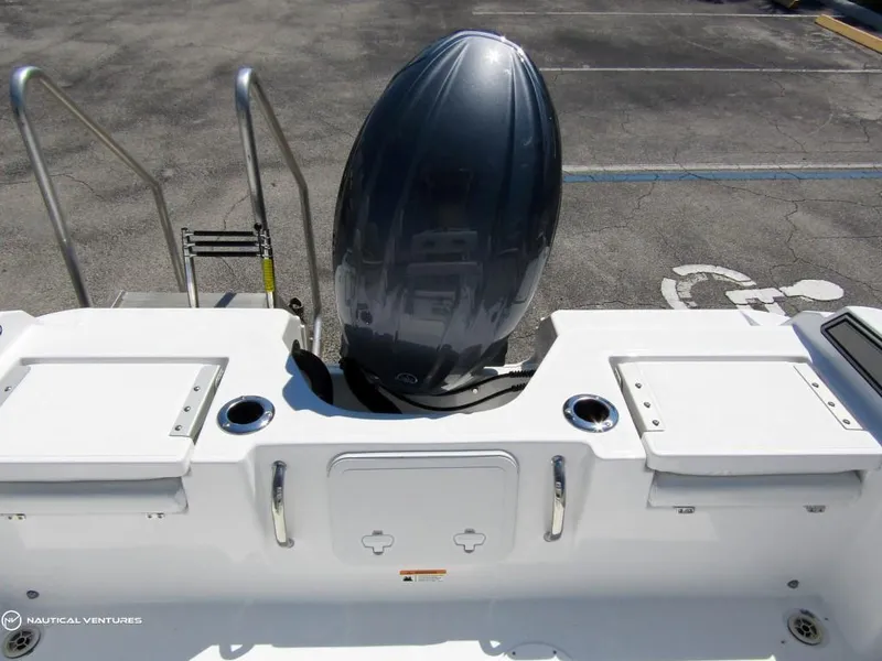 Slide: The Image of 2024 Wellcraft 202 Fisherman boat stern with outboard motor and storage compartments. - 22