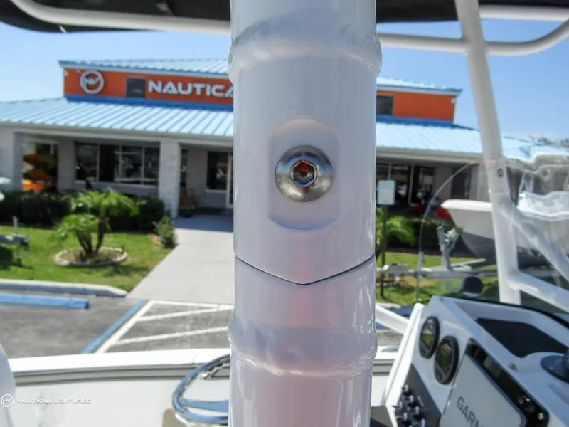 Slide: The Image of Close-up of 2024 Wellcraft 202 Fisherman boat detail with dealership in background. - 26