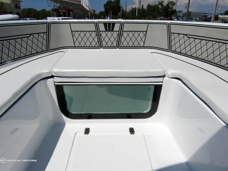 Slide: The Image of 2024 Wellcraft 202 Fisherman boat interior with cushioned seating and storage compartments. - 6