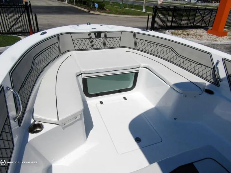 Slide: The Image of 2024 Wellcraft 202 Fisherman boat interior with cushioned seating and storage compartments. - 7