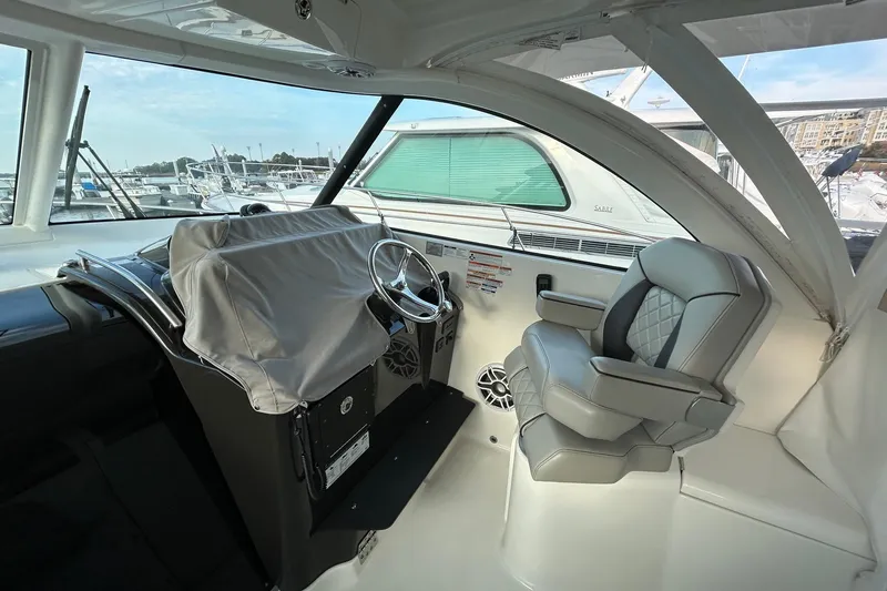Slide: The Image of 2023 Pursuit OS 385 Offshore helm with covered controls and luxurious seating. - 3