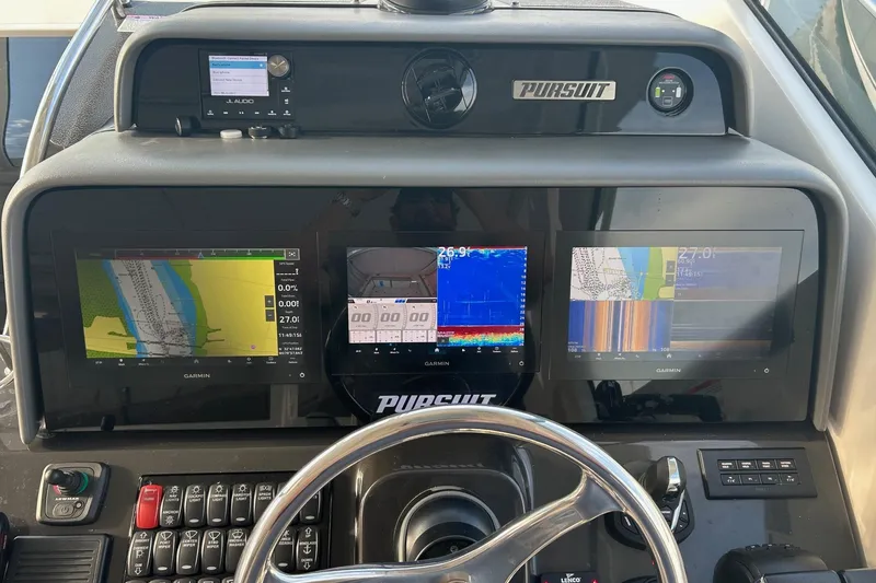Slide: The Image of 2023 Pursuit OS 385 Offshore boat dashboard with Garmin navigation displays. - 6