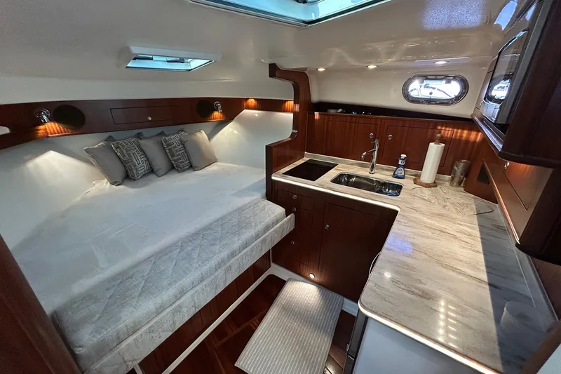 Slide: The Image of Luxurious interior of 2023 Pursuit OS 385 Offshore yacht with bed and kitchenette. - 7