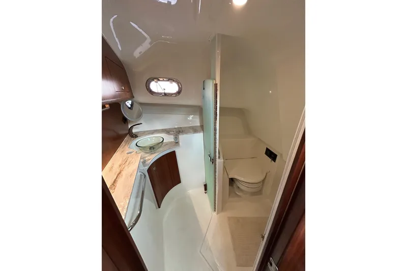 Slide: The Image of 2023 Pursuit OS 385 Offshore boat bathroom with modern fixtures and elegant design. - 8