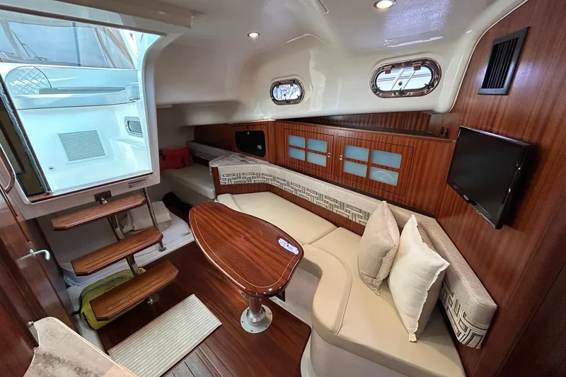 Slide: The Image of Luxurious interior of 2023 Pursuit OS 385 Offshore boat with elegant seating and wooden finishes. - 9