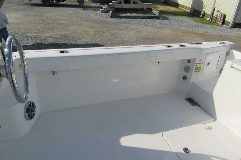 Slide: The Image of 2026 Parker 227 Explorer Sport Cabin boat interior with steering wheel and storage compartments. - 11