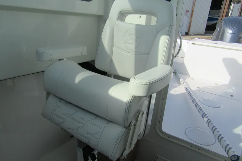 Slide: The Image of 2026 Parker 227 Explorer Sport Cabin boat seat with armrests, featuring sleek white upholstery. - 15