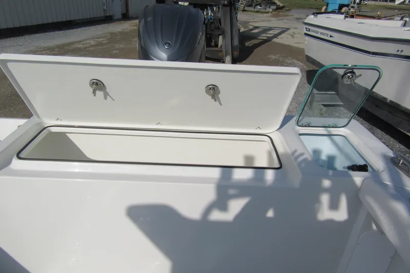 Slide: The Image of 2026 Parker 227 Explorer Sport Cabin boat with open storage compartments. - 7