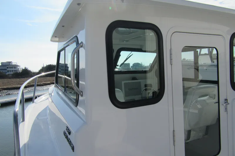 Slide: The Image of 2026 Parker 227 Explorer Sport Cabin boat, featuring sleek design and modern cabin windows. - 9