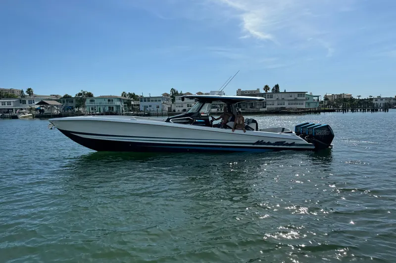 Slide: The Image of 2024 Nor-Tech 400 Supersport boat on water, with modern design and powerful engines. - 4