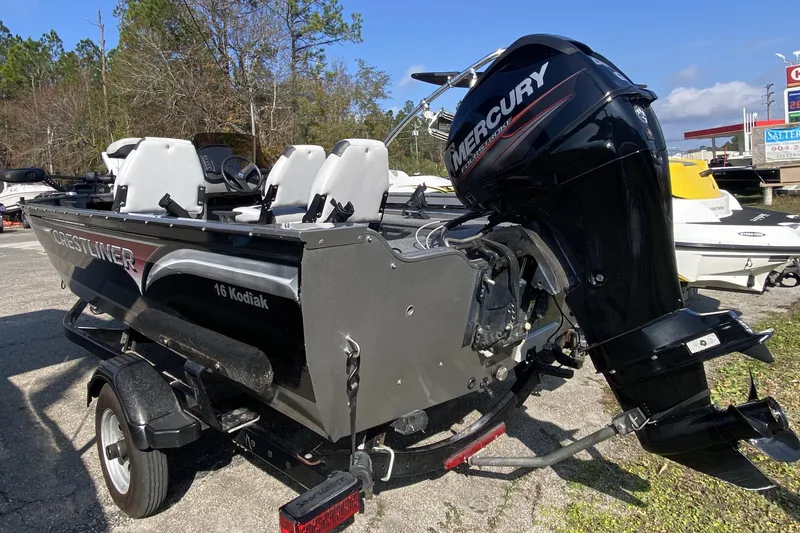 Slide: The Image of 2013 Crestliner 16 SC boat with Mercury outboard motor, parked outdoors. - 3