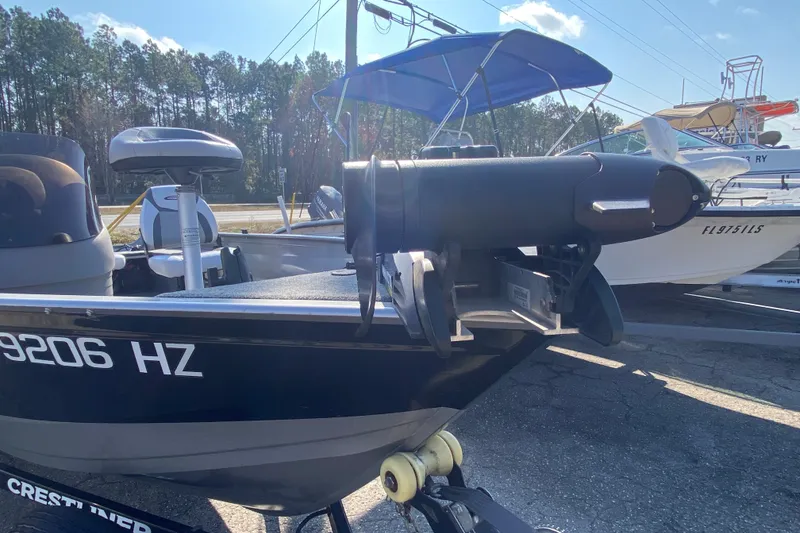 Slide: The Image of 2013 Crestliner 16 SC boat with motor, parked on trailer, sunny day. - 5