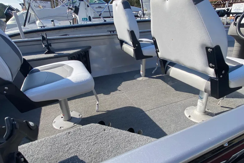 Slide: The Image of 2013 Crestliner 16 SC boat interior with two swivel seats and carpeted flooring. - 7