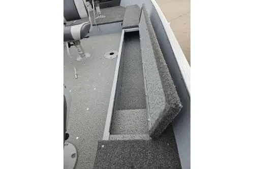 Slide: The Image of 2012 Lund 1600 Fury Tiller boat interior with open storage compartment. - 3