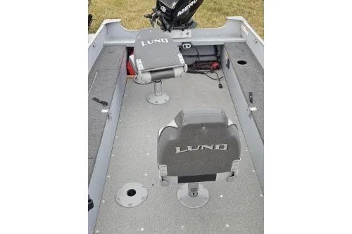 Slide: The Image of 2012 Lund 1600 Fury Tiller boat interior with seating and storage compartments. - 4