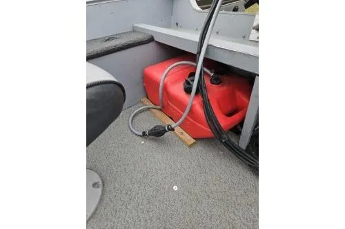 Slide: The Image of 2012 Lund 1600 Fury Tiller boat interior with red fuel tank and hose. - 7