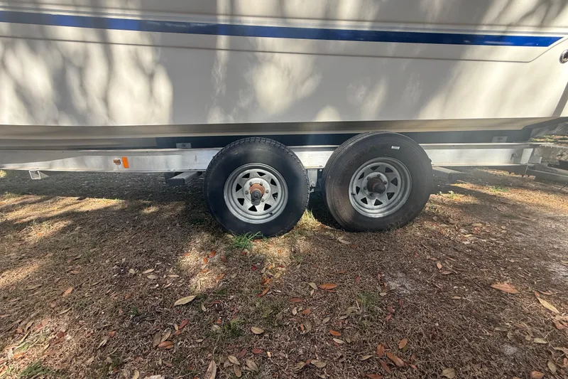 Slide: The Image of 2004 Monterey 265 Cruiser interior with white seating and modern dashboard. - 15