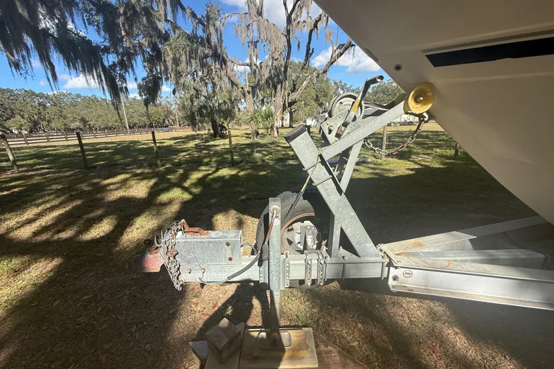 Slide: The Image of 2004 Monterey 265 Cruiser dashboard with Garmin navigation, surrounded by parked boats. - 17