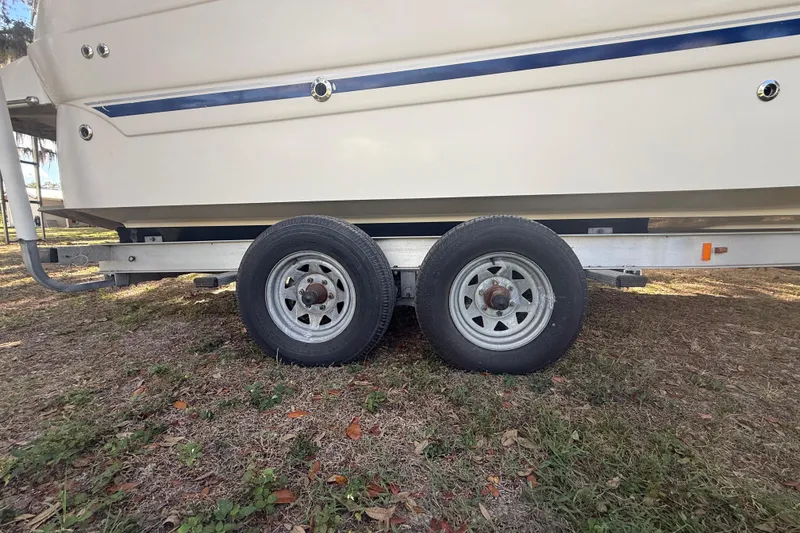 Slide: The Image of 2004 Monterey 265 Cruiser interior with kitchenette, sink, and cozy seating area. - 18