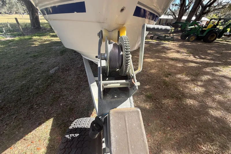 Slide: The Image of 2004 Monterey 265 Cruiser interior with tan leather seating and wooden table. - 19