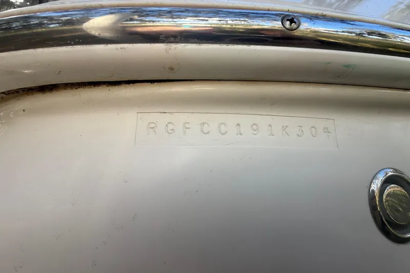 Slide: The Image of 2004 Monterey 265 Cruiser bathroom with sink, toilet, and porthole window. - 28