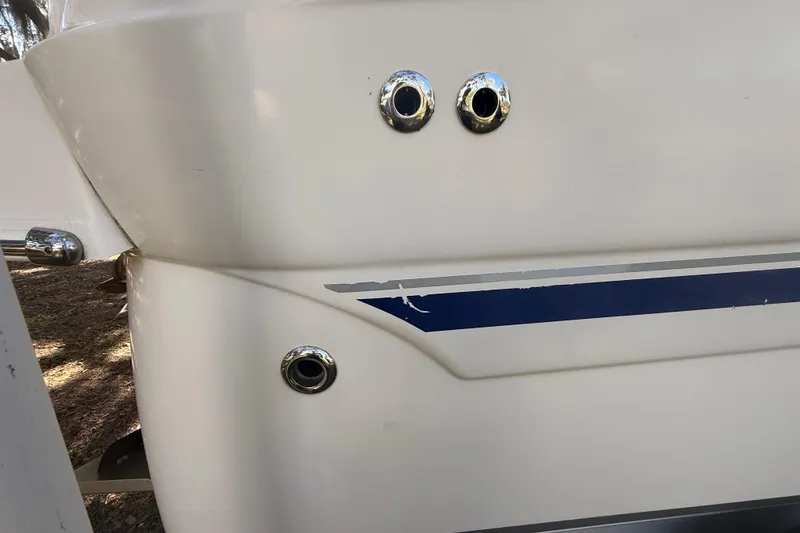 Slide: The Image of 2004 Monterey 265 Cruiser bathroom with sink, toilet, and porthole windows. - 29