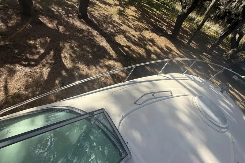 Slide: The Image of 2004 Monterey 265 Cruiser boat deck with railing and anchor, viewed from above. - 38