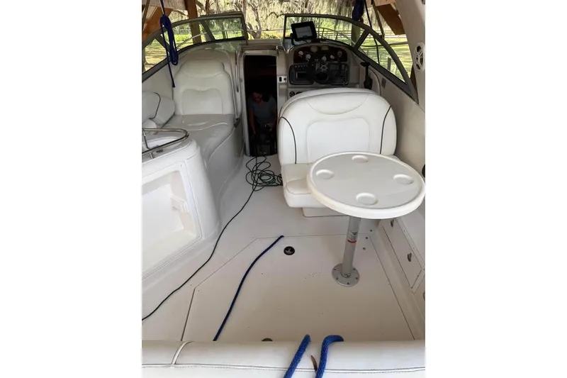 Slide: The Image of 2004 Monterey 265 Cruiser boat on trailer under clear blue sky. - 4