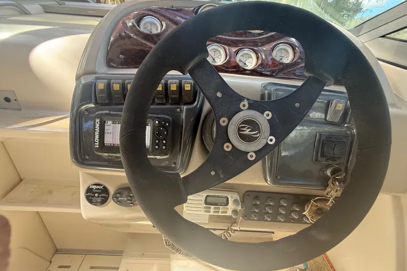Slide: The Image of 2004 Monterey 265 Cruiser boat on display, viewed from above, with sale banners. - 42