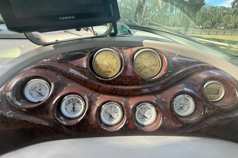 Slide: The Image of 2004 Monterey 265 Cruiser interior with white seating and helm, showcasing luxury design. - 44