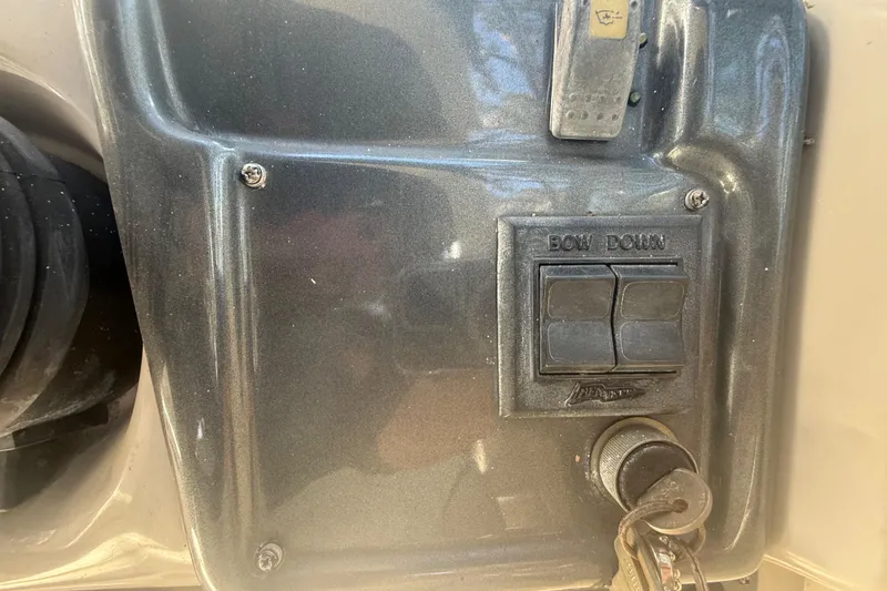 Slide: The Image of 2004 Monterey 265 Cruiser interior with white seating and steering console. - 46