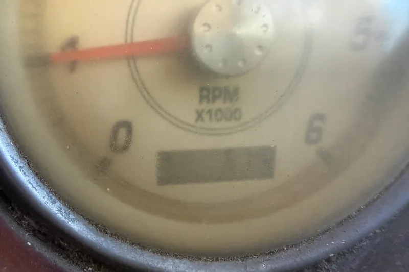 Slide: The Image of 2004 Monterey 265 Cruiser interior with white seating and cup holders. - 48