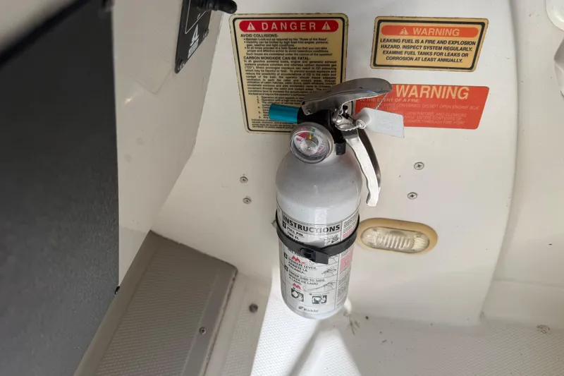 Slide: The Image of 2004 Monterey 265 Cruiser boat interior with white seating and storage compartments. - 49