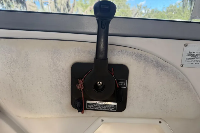 Slide: The Image of 2004 Monterey 265 Cruiser boat interior with white seating and storage compartments. - 50