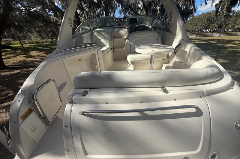 Slide: The Image of 2004 Monterey 265 Cruiser boat deck with white finish and metal fittings. - 53
