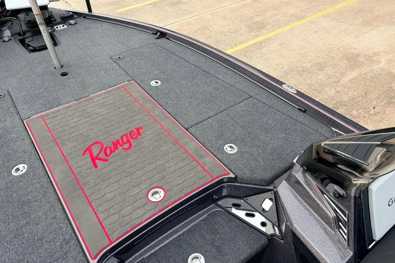 Slide: The Image of 2025 Ranger Z521R Cup-Equipped boat deck with logo and carpeted surface. - 16