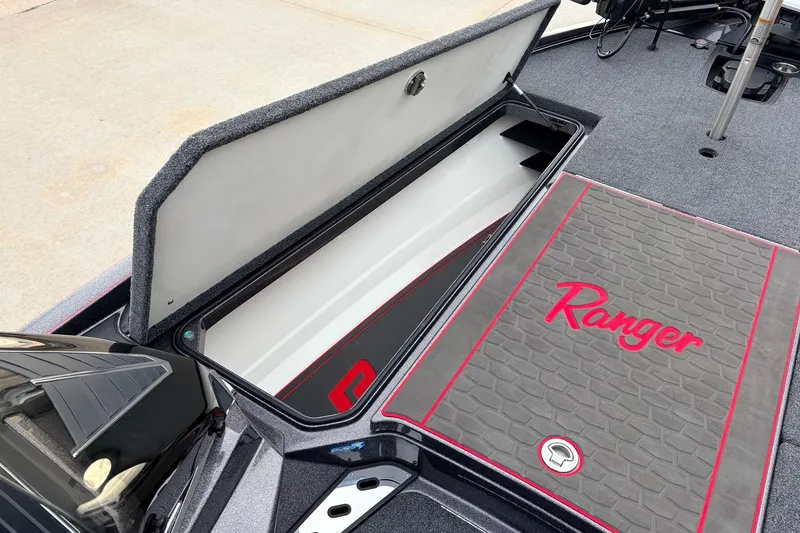 Slide: The Image of 2025 Ranger Z521R Cup-Equipped boat storage compartment with open lid and branded mat. - 17