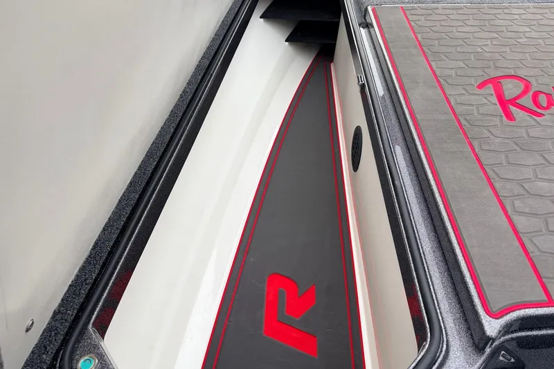 Slide: The Image of 2025 Ranger Z521R Cup-Equipped boat interior with red accents and storage compartment. - 18