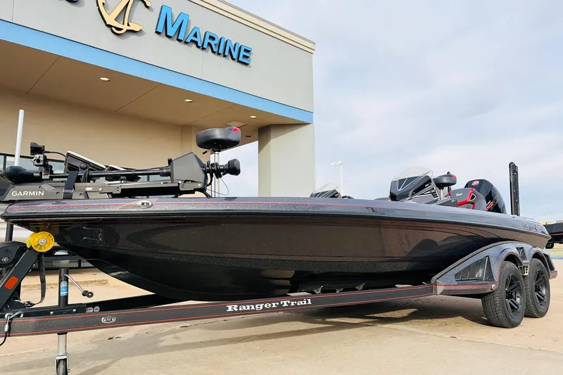 Slide: The Image of 2025 Ranger Z521R Cup-Equipped boat on trailer outside marine dealership. - 2