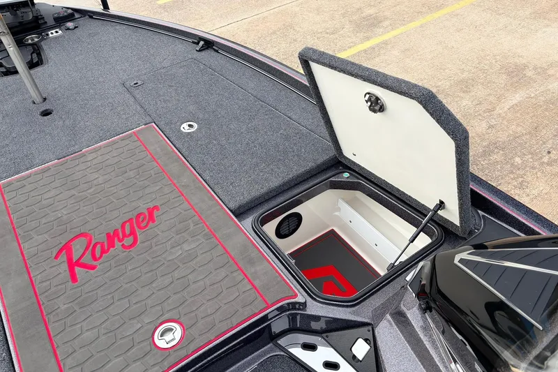 Slide: The Image of 2025 Ranger Z521R Cup-Equipped boat with open storage compartment and branded deck mat. - 23