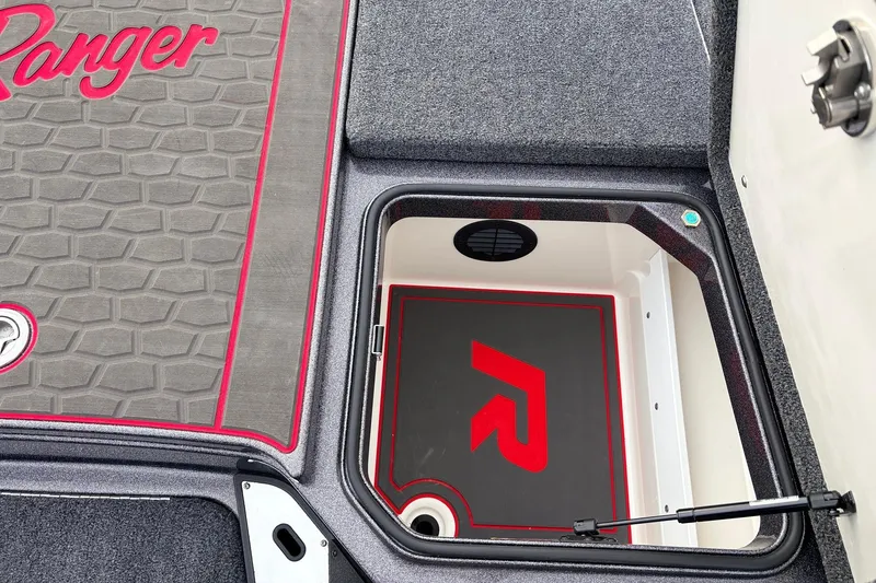 Slide: The Image of 2025 Ranger Z521R Cup-Equipped boat storage compartment with logo and textured flooring. - 24
