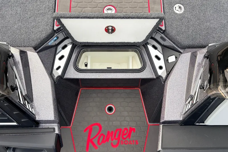 Slide: The Image of 2025 Ranger Z521R Cup-Equipped boat interior with storage compartment and logo. - 26