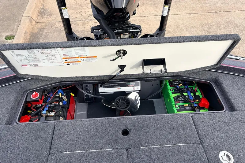 Slide: The Image of 2025 Ranger Z521R Cup-Equipped boat battery compartment with wiring and storage. - 54