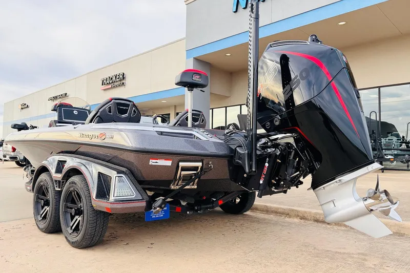 Slide: The Image of 2025 Ranger Z521R Cup-Equipped boat with powerful outboard motor, parked outside dealership. - 7