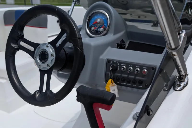 Slide: The Image of Steering wheel and dashboard of 2022 Tahoe T16 boat, featuring control panel and gauges. - 3